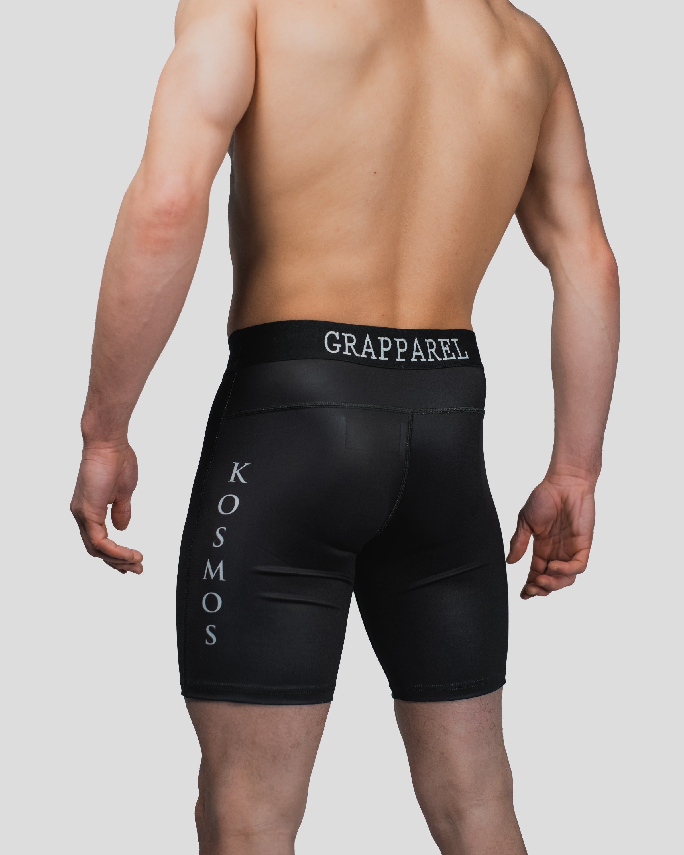 Rear view of the All Strength Shorts, displaying the Grapparel waistband branding and Kosmos lettering along the side