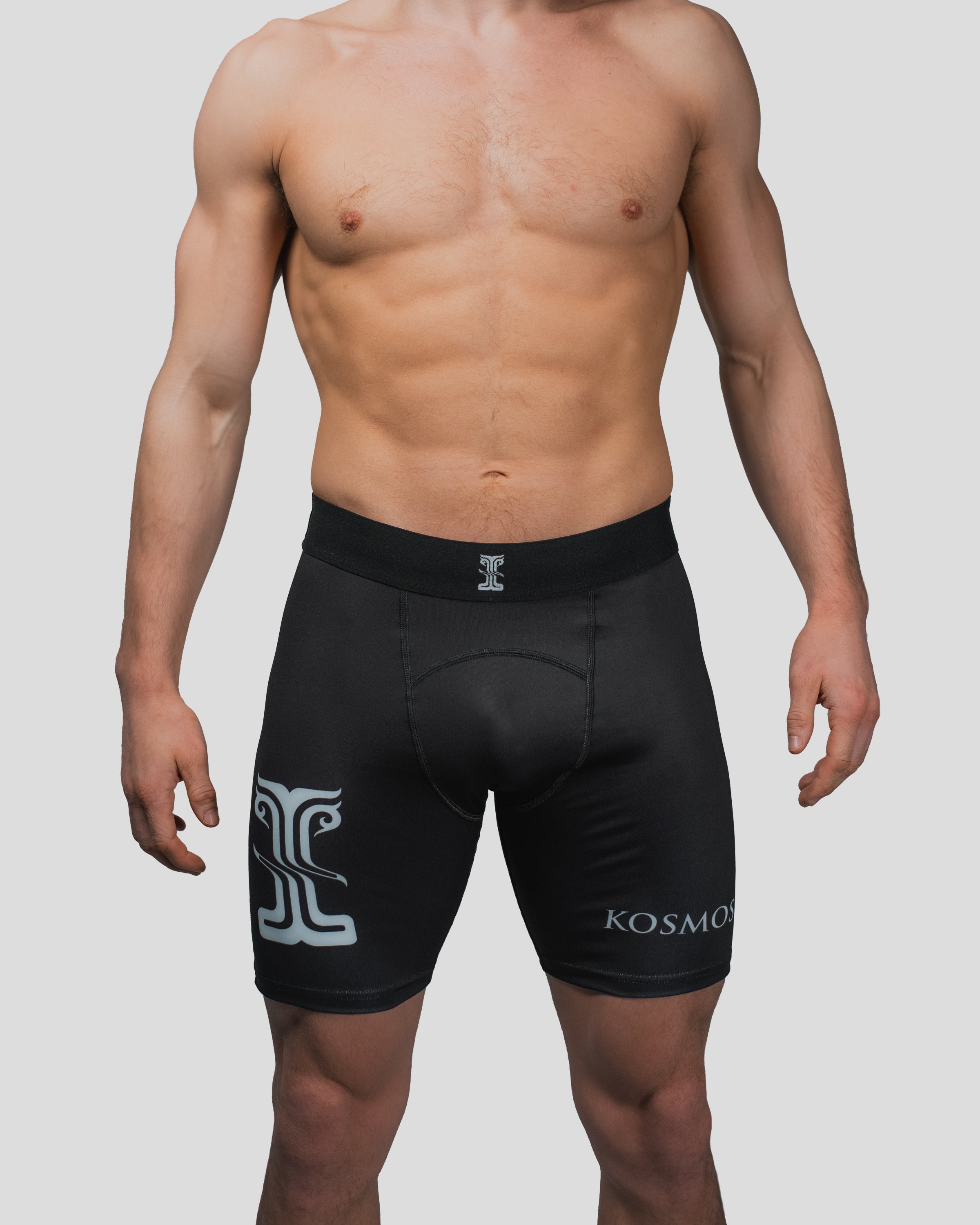 Front view of the All Strength Shorts, showcasing the fitted design with Kosmos branding on the left leg