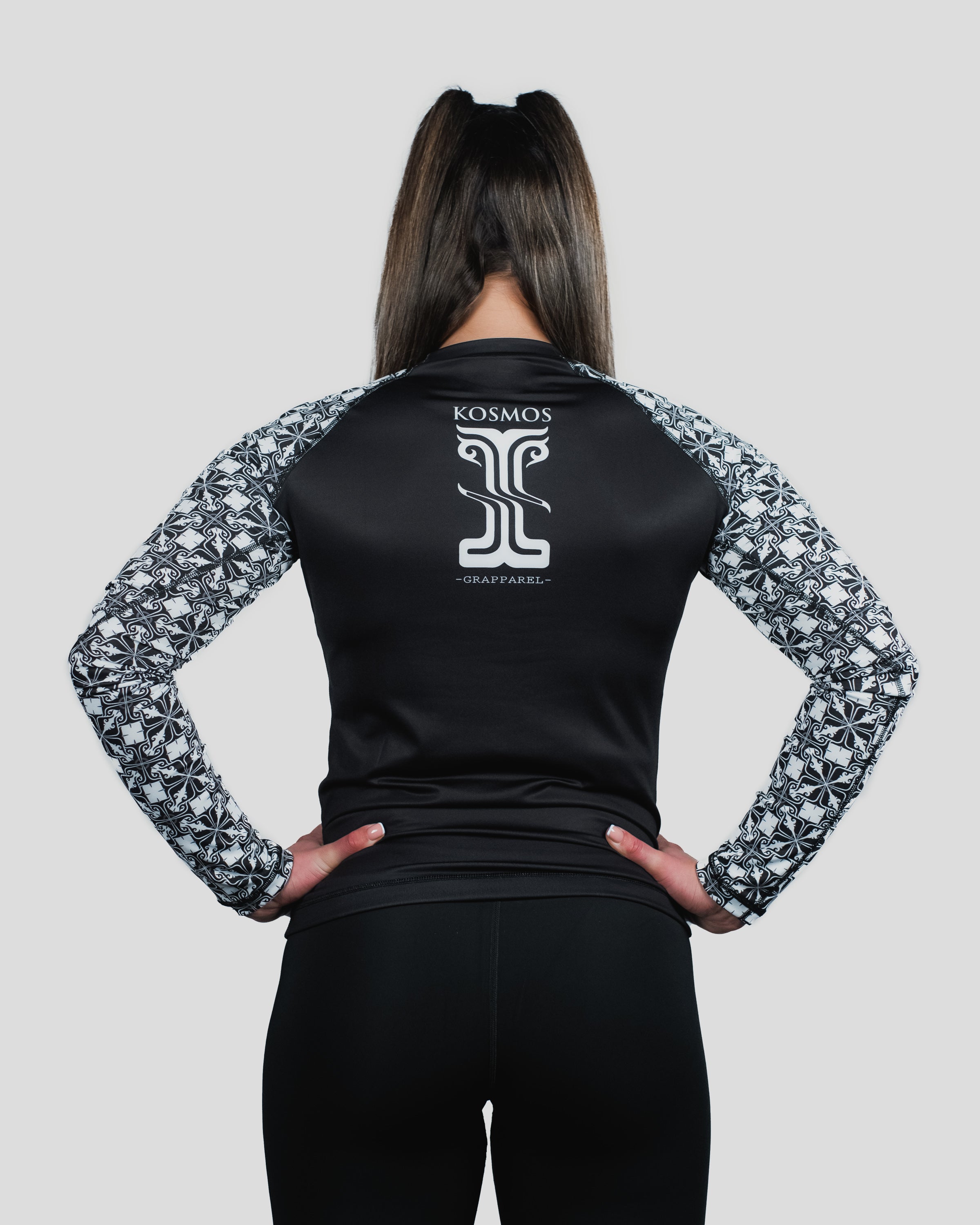 Rear view of the Gorgo Long Sleeve Rash Guard, highlighting the "Kosmos" branding and elegant monochrome design