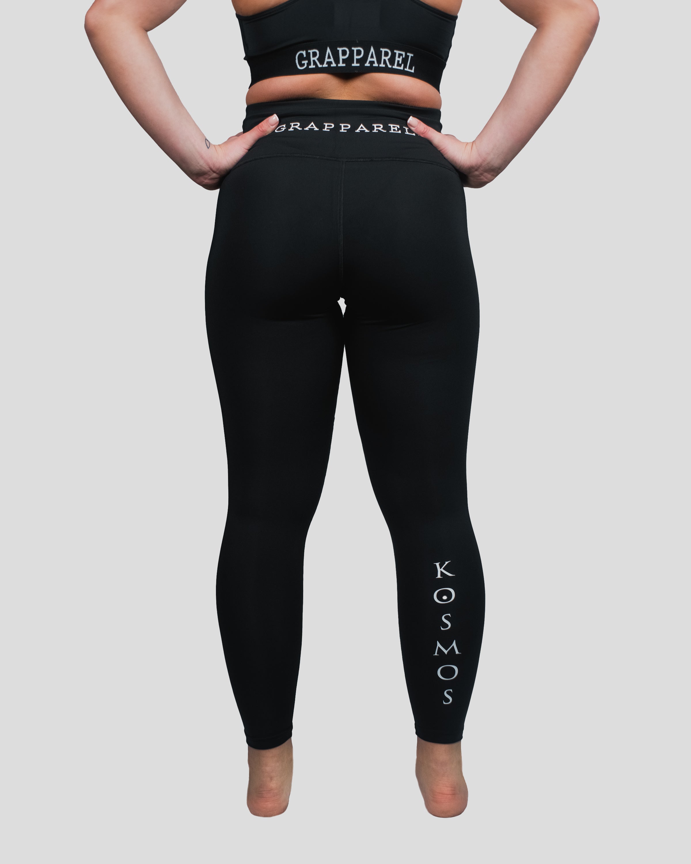 Back view of Gorgo Spats, highlighting the contoured fit, high-waistband with "Grapparel" branding, and Kosmos logo on the lower leg