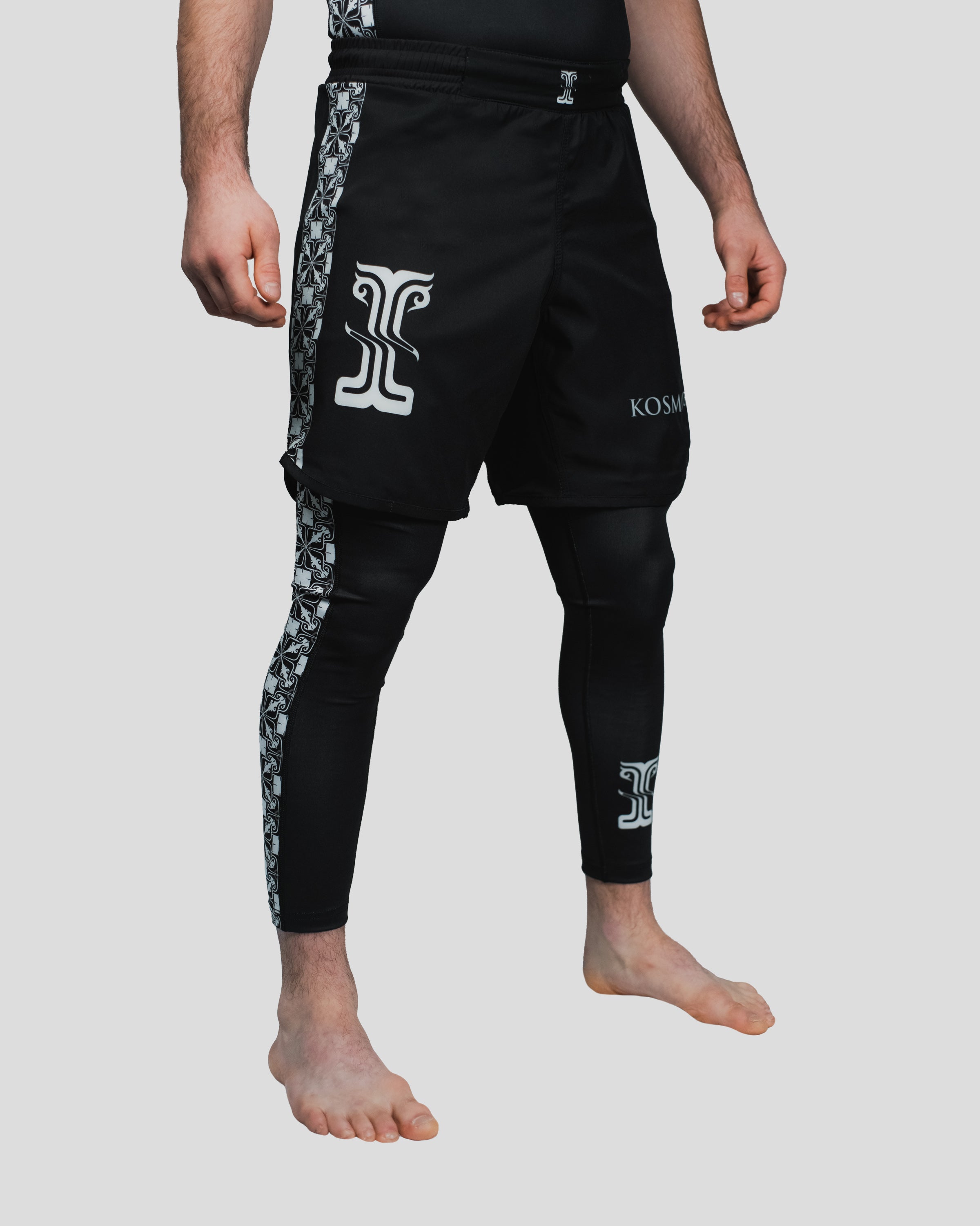 Side view of the Persist Shorts paired with Kosmos Spats, showcasing premium stretch fabric and intricate branding detail