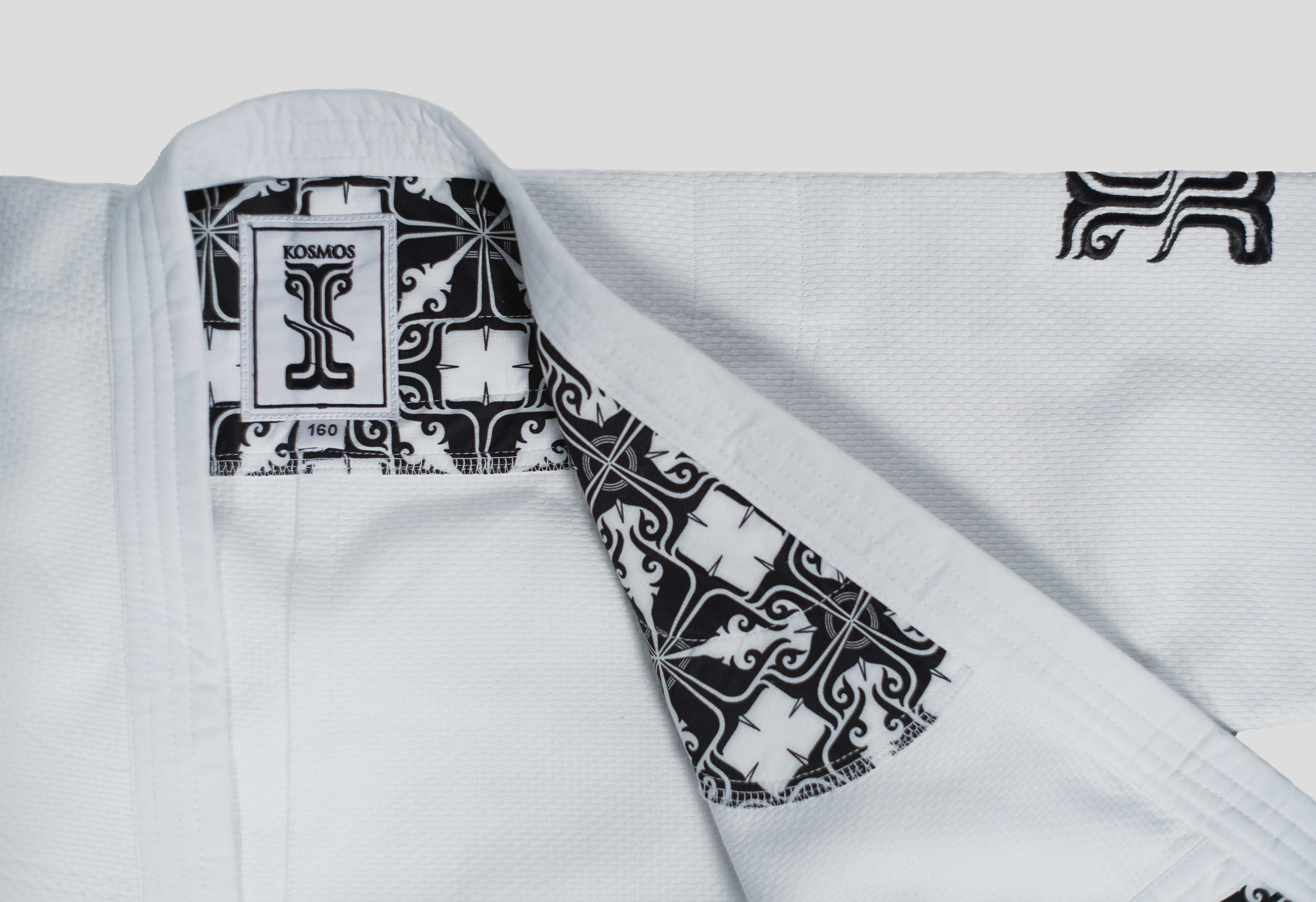 Close-up of the Stoa Gi Men's Judo uniform, showcasing the black and white Kosmos label and intricate inner lining design