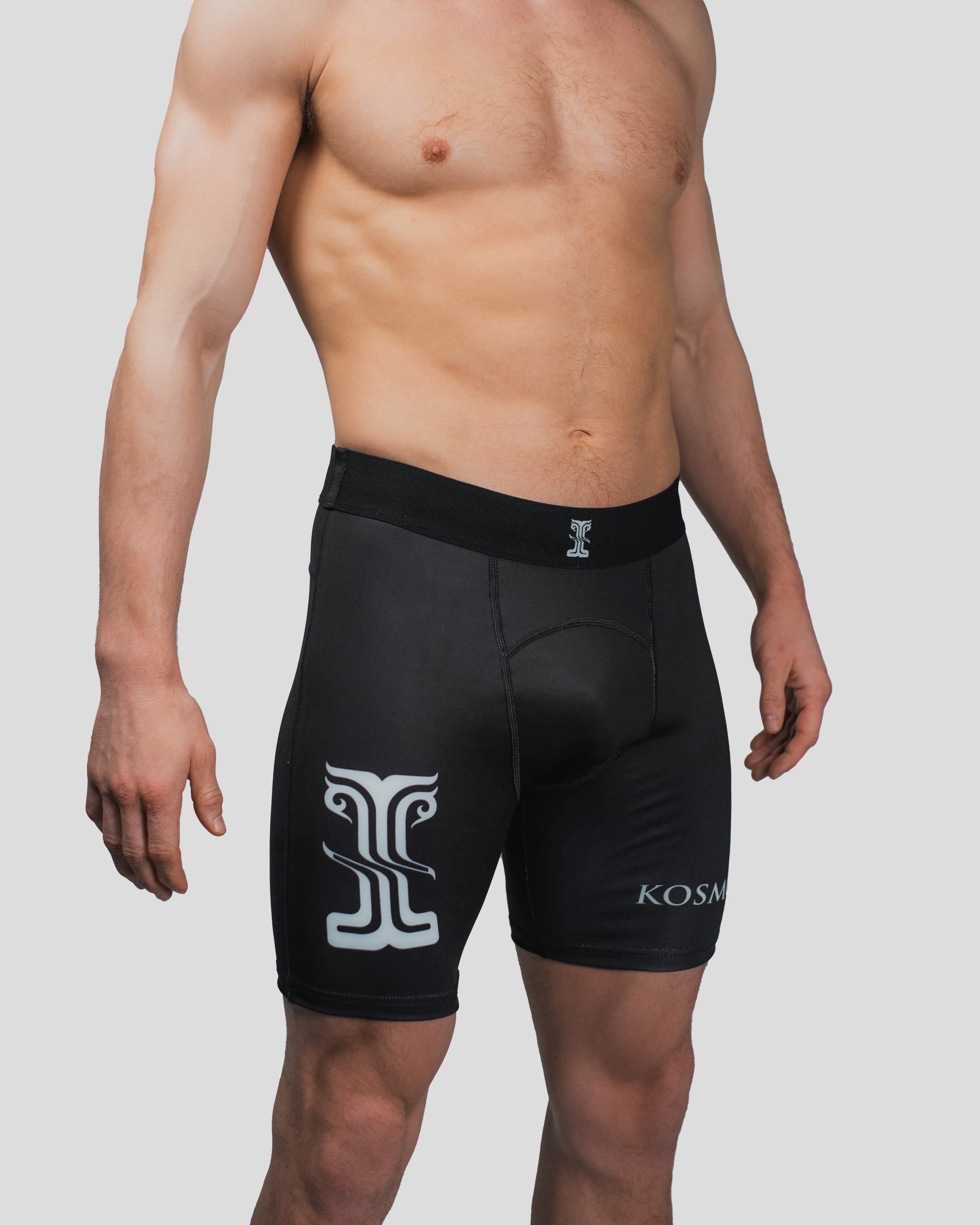 Side profile of the All Strength Shorts, highlighting the ergonomic fit and bold logo placement
