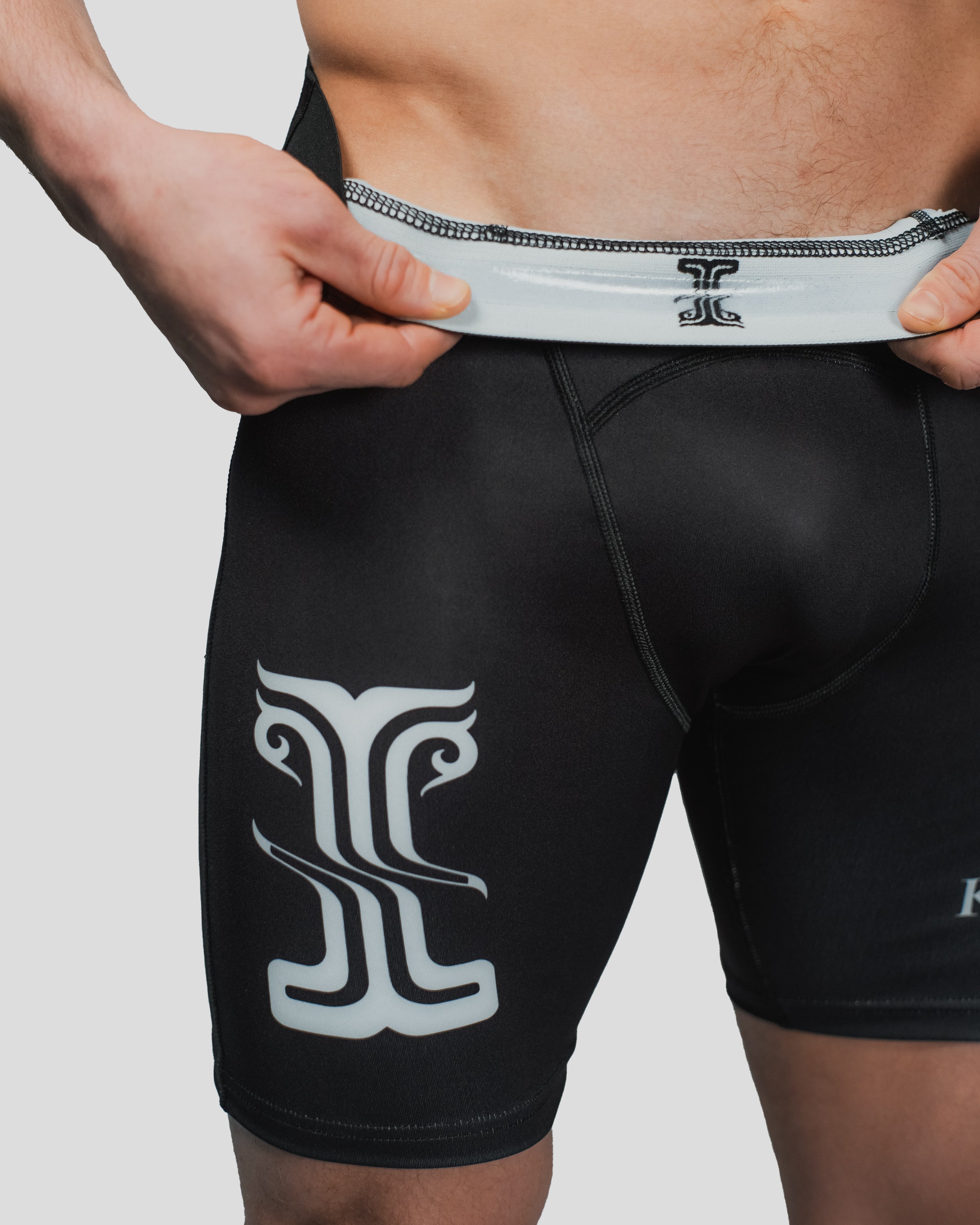 Close-up of the inner waistband of the All Strength Shorts, featuring a detailed logo print and reinforced stitching