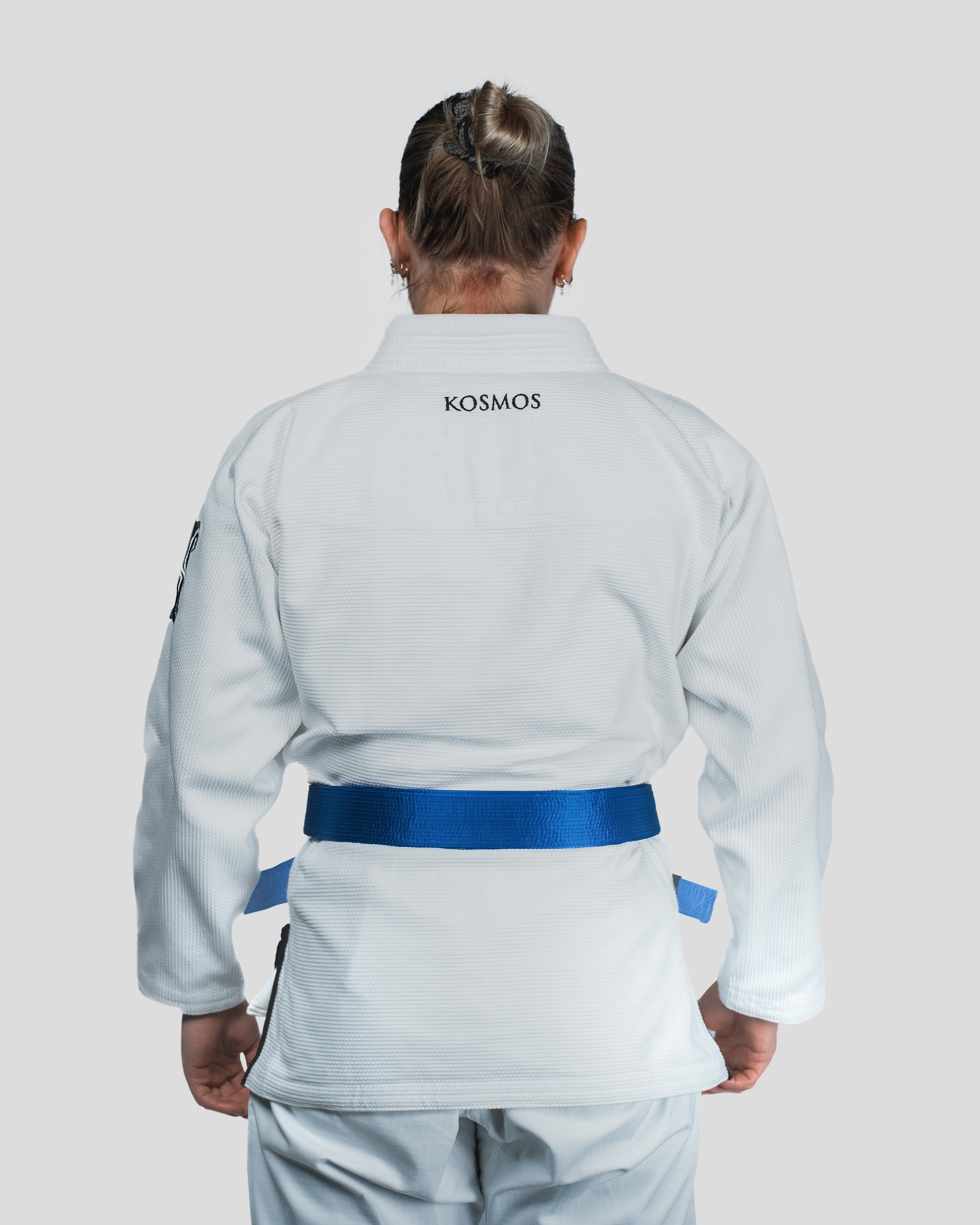 Back view of the Guile Women's Jiu Jitsu Gi, featuring minimalist Kosmos branding and a tailored cut for competition and training
