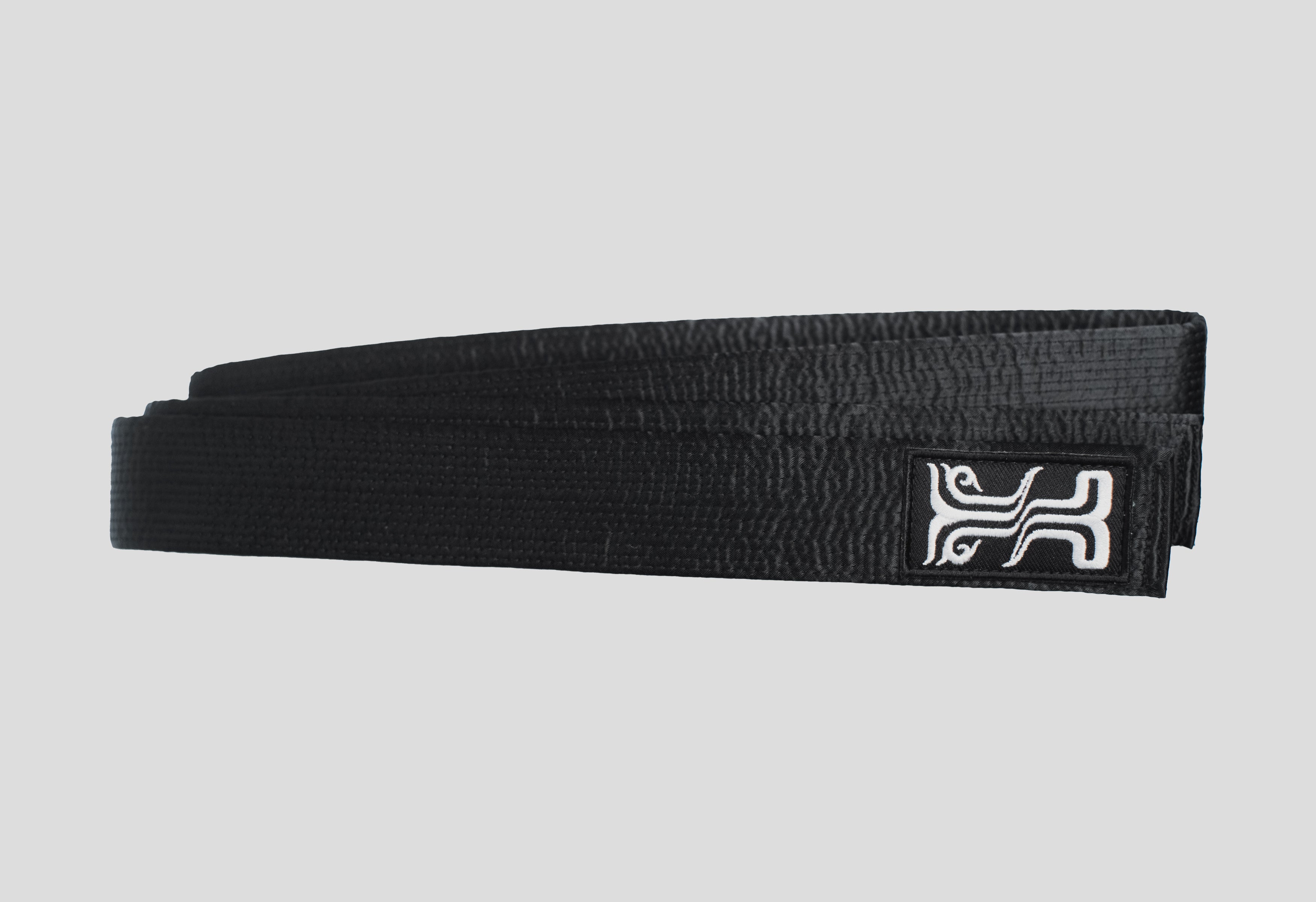 Phobos Black Judo Belt, folded with the Kosmos embroidered logo, designed for durability and professional martial arts training