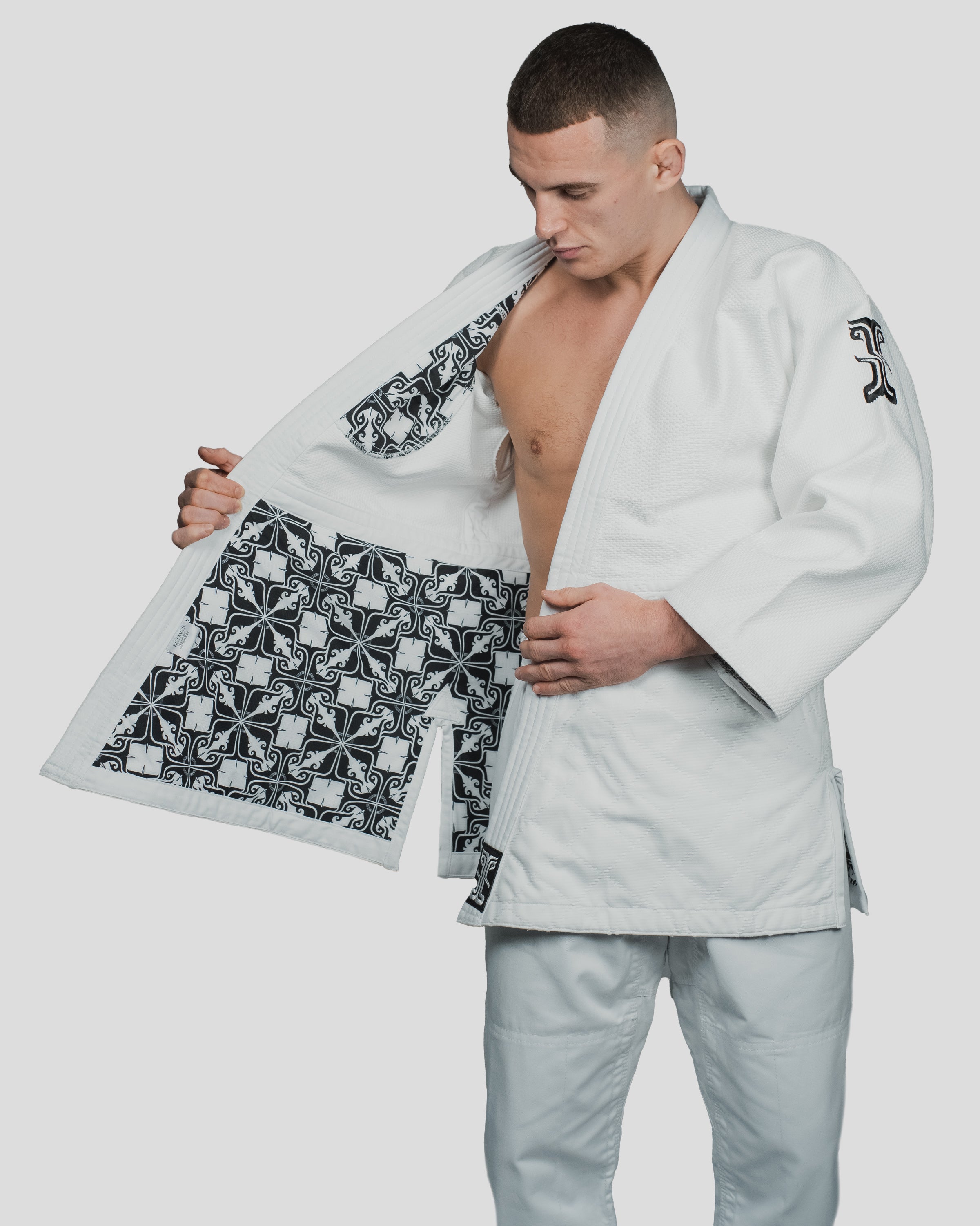 Detailed view of the Stoa Gi Men's Judo uniform with the jacket open, highlighting the interior artwork and reinforced stitching