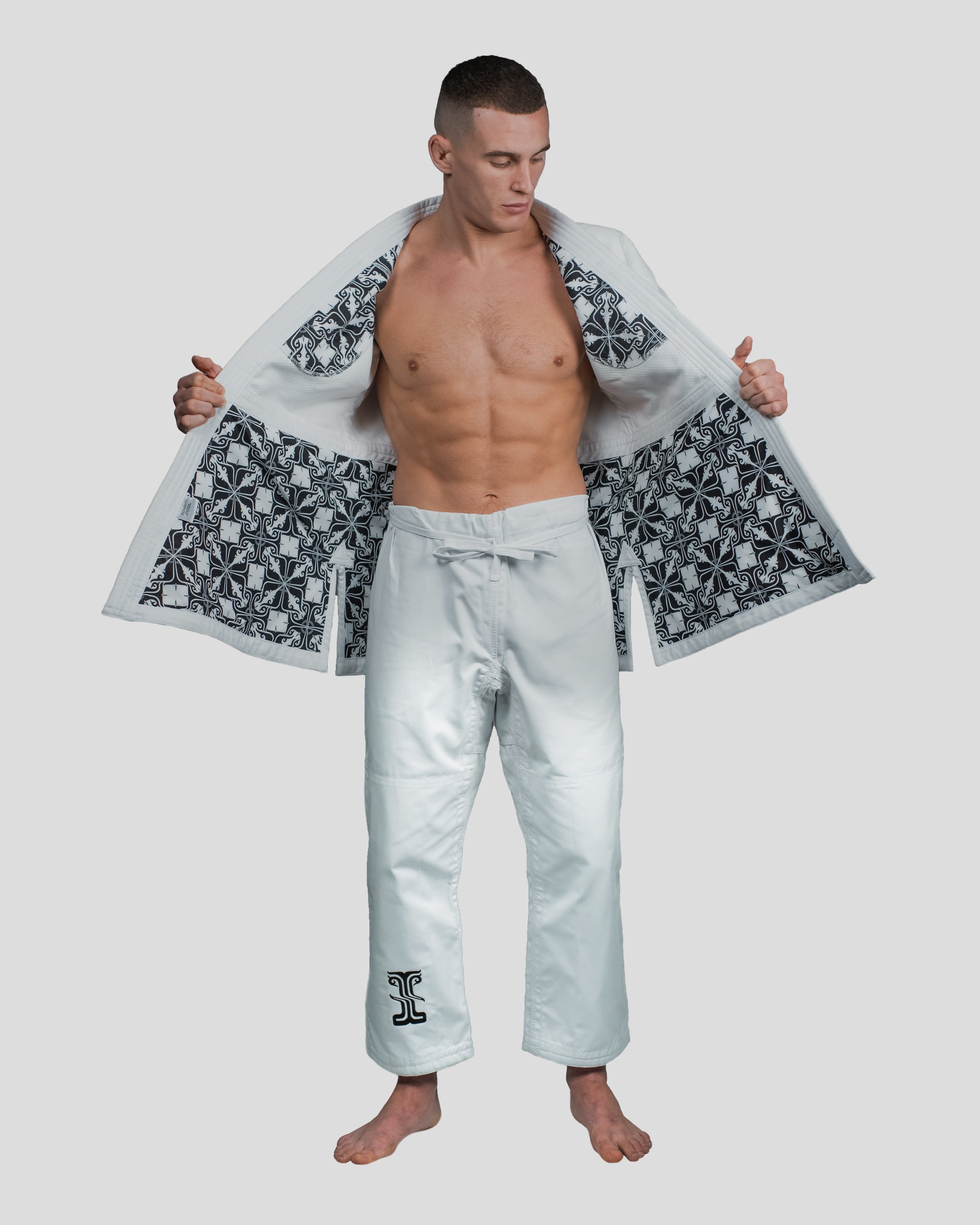 Martial artist wearing the Stoa Gi Men's Judo uniform with the jacket open, revealing the patterned inner lining
