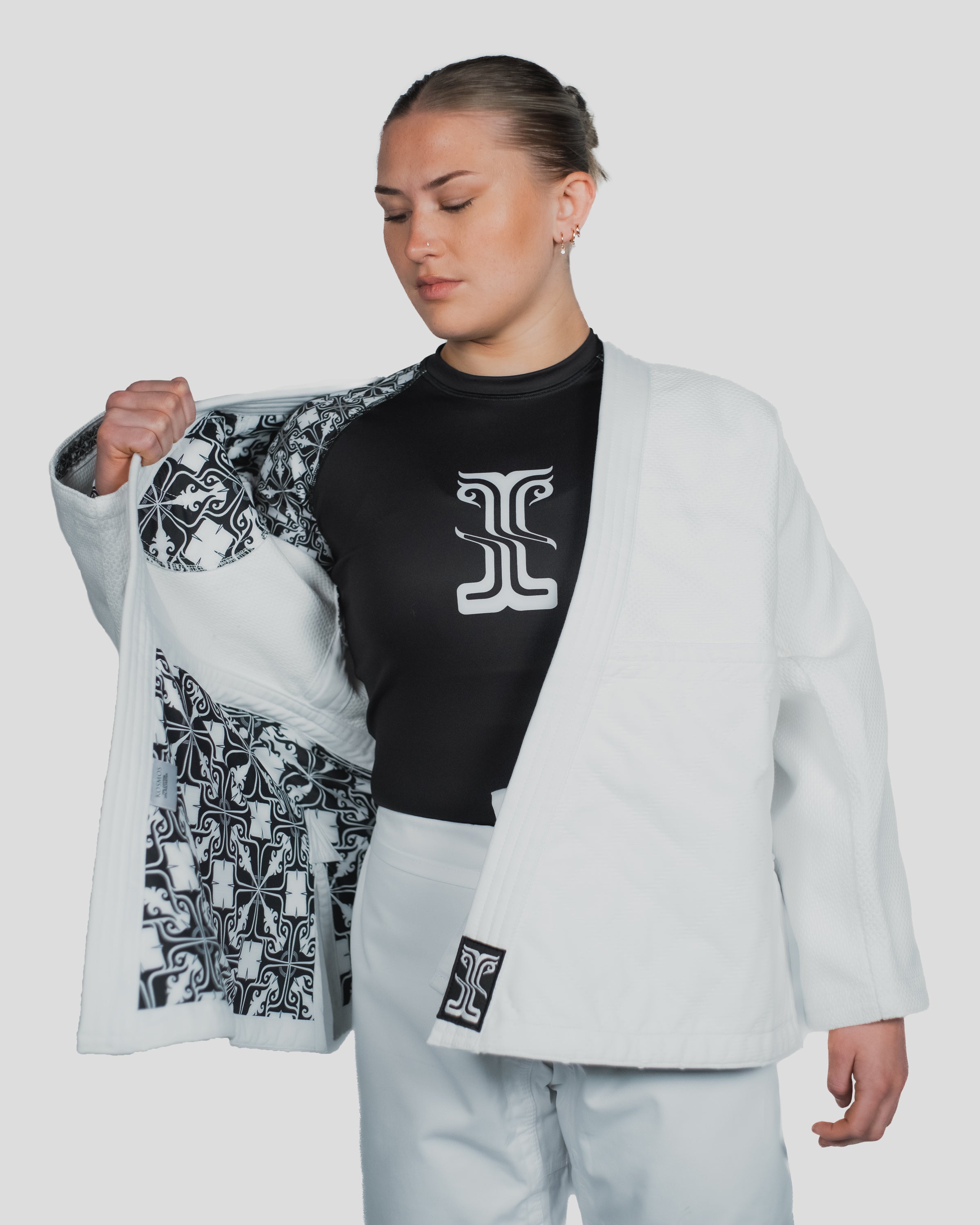 Stoa Gi Women's Judo uniform with the jacket open, revealing a Kosmos-branded rash guard and the detailed inner lining design